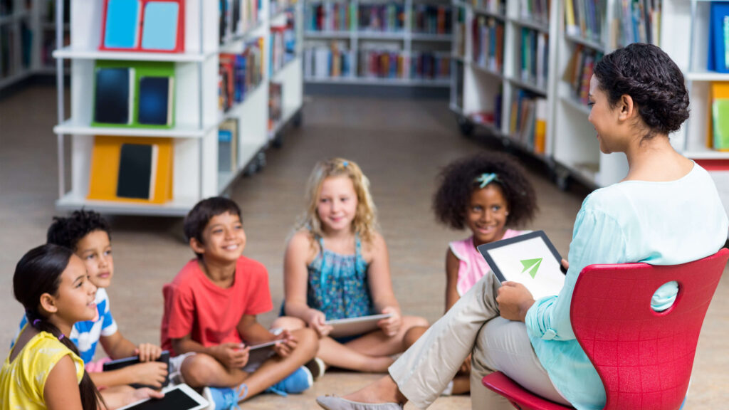 woman teaching young pupils for international education recruitment report 2022