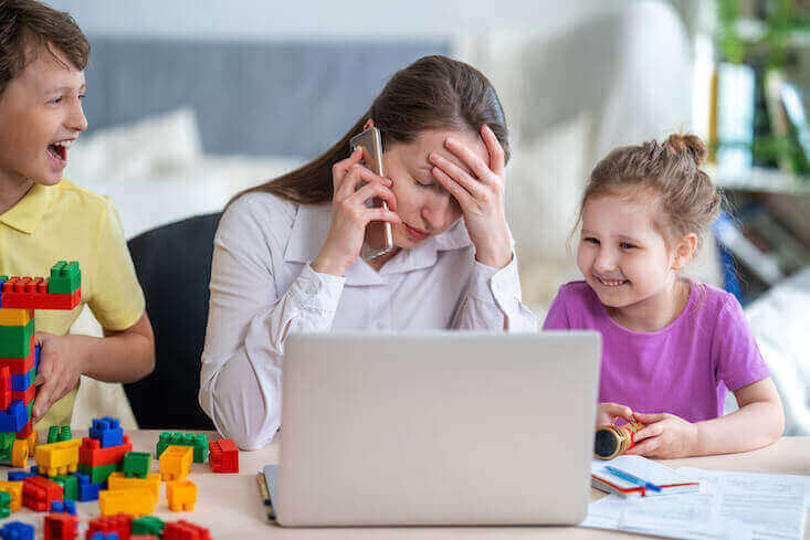 Mom working from home stressed by remote schooling.